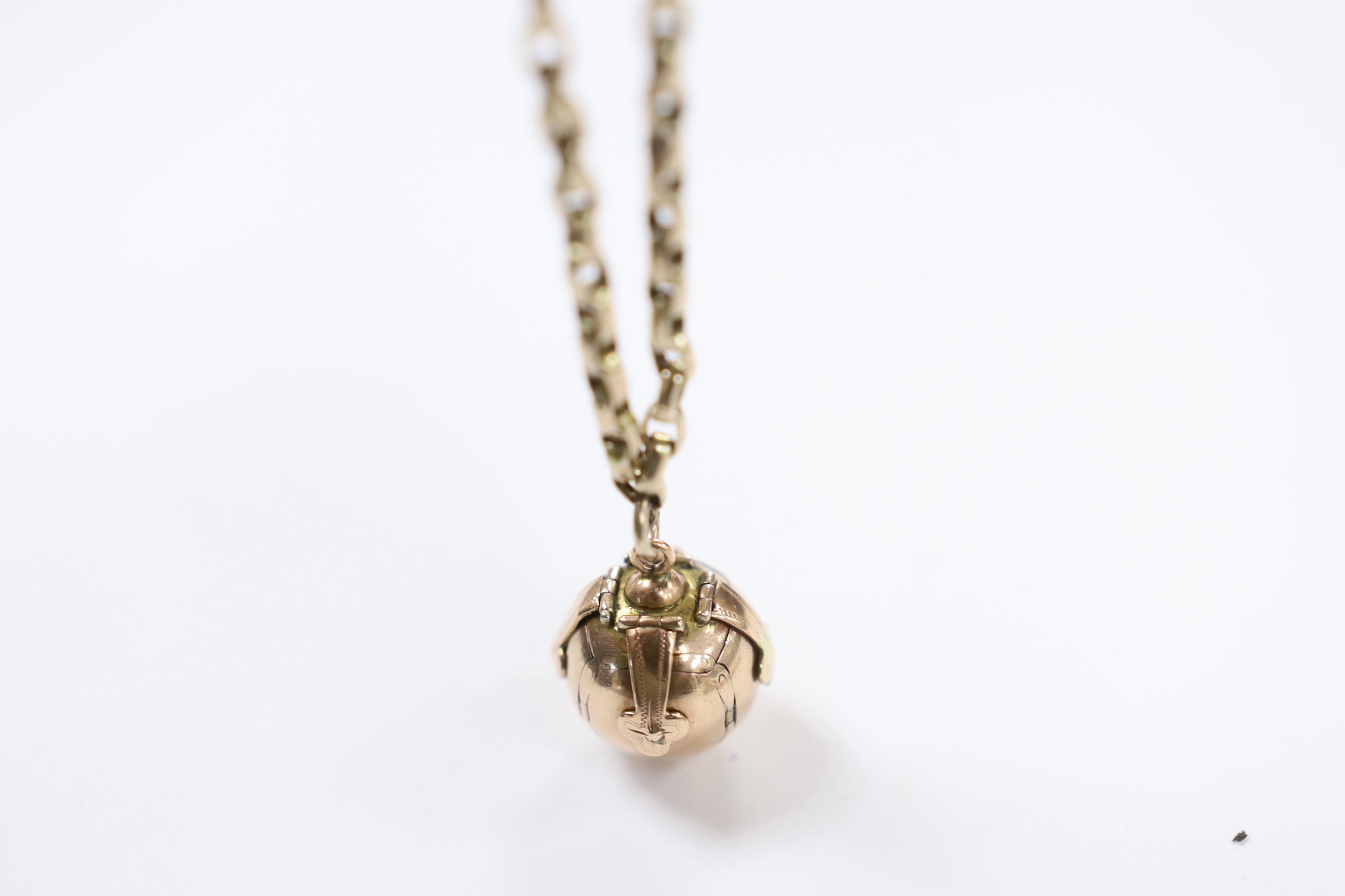 A yellow metal overlaid fob seal on a damaged 9ct gold bracelet, together with a yellow metal masonic ball on a yellow metal chain.